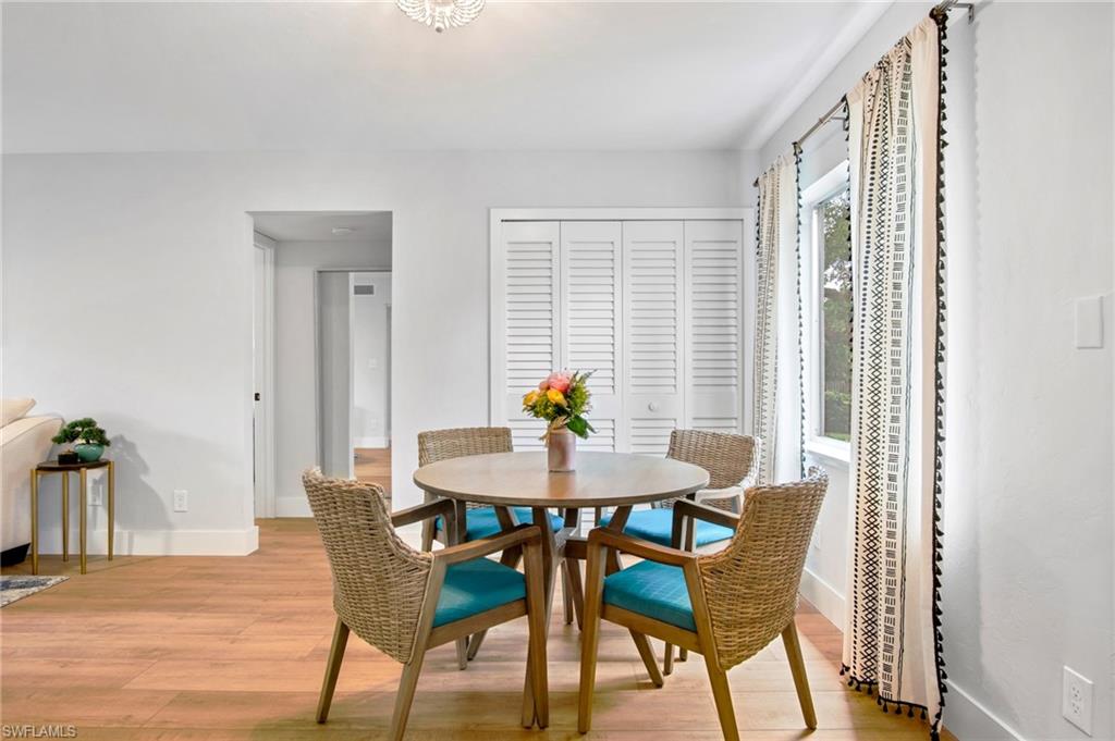 1275 7th Avenue North, Unit 201 Naples, FL 34102 - Photo 11 of 39 Dining room featuring light wood-type flooring and baseboards