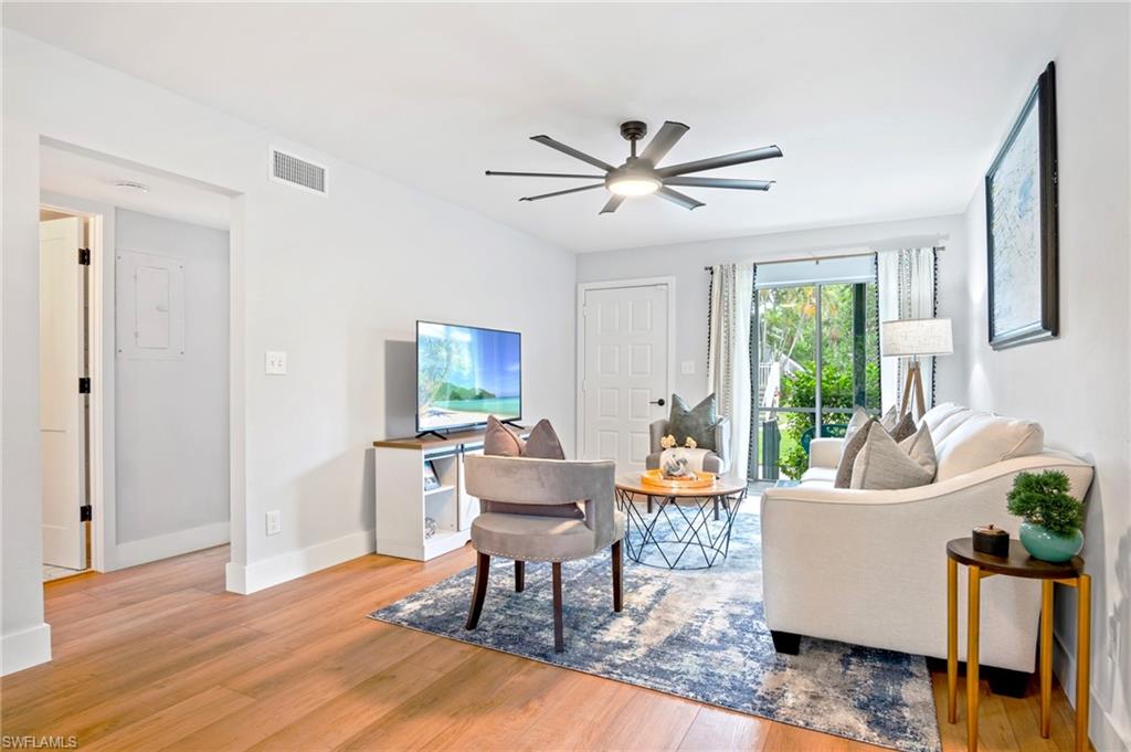 1275 7th Avenue North, Unit 201 Naples, FL 34102 - Photo 16 of 39 Living room featuring wood finished floors and ceiling fan