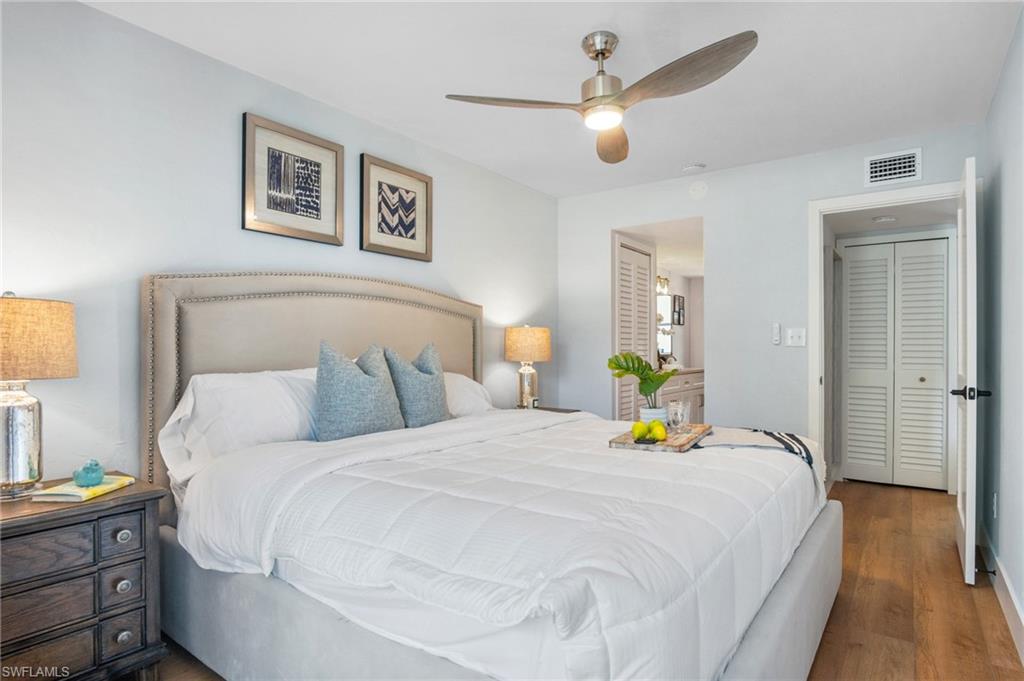 1275 7th Avenue North, Unit 201 Naples, FL 34102 - Photo 19 of 39 Bedroom featuring wood finished floors and a ceiling fan