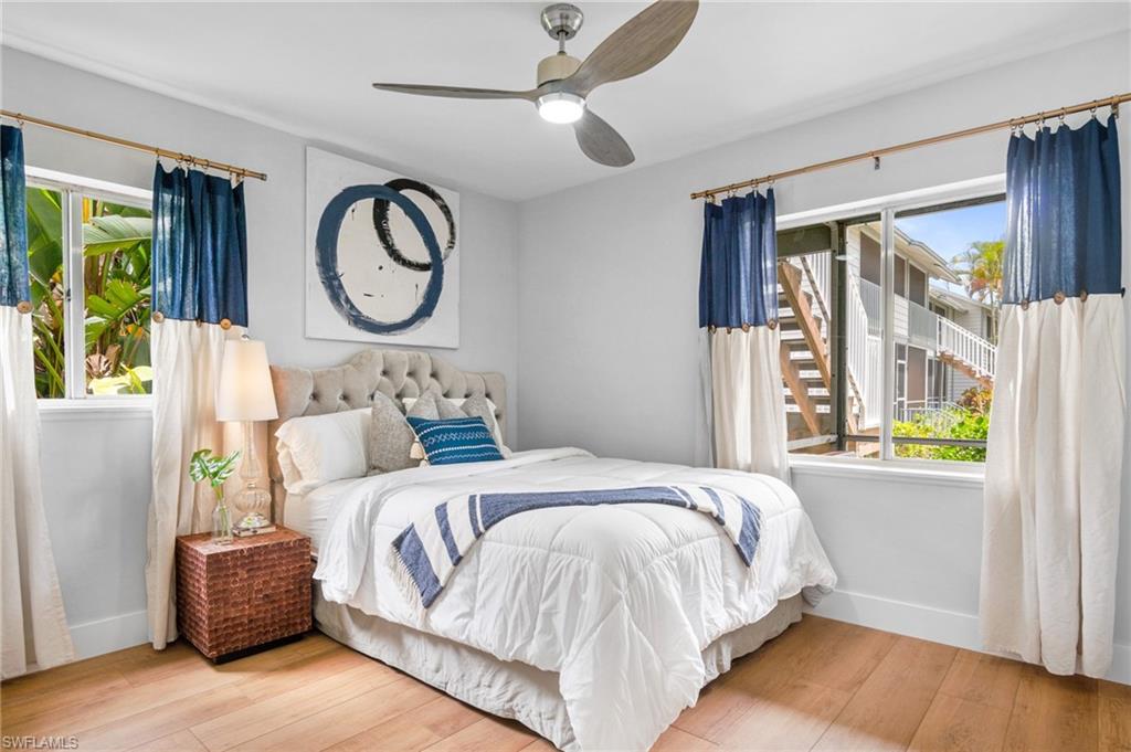 1275 7th Avenue North, Unit 201 Naples, FL 34102 - Photo 24 of 39 Bedroom with wood finished floors and a ceiling fan