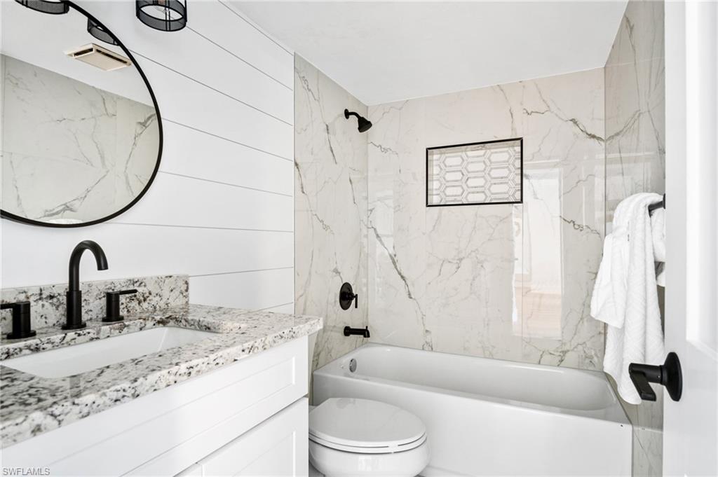 1275 7th Avenue North, Unit 201 Naples, FL 34102 - Photo 26 of 39 Full bathroom featuring vanity and bathtub / shower combination