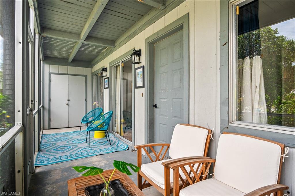 1275 7th Avenue North, Unit 201 Naples, FL 34102 - Photo 30 of 39 Sunroom with healthy amount of natural light and beam ceiling