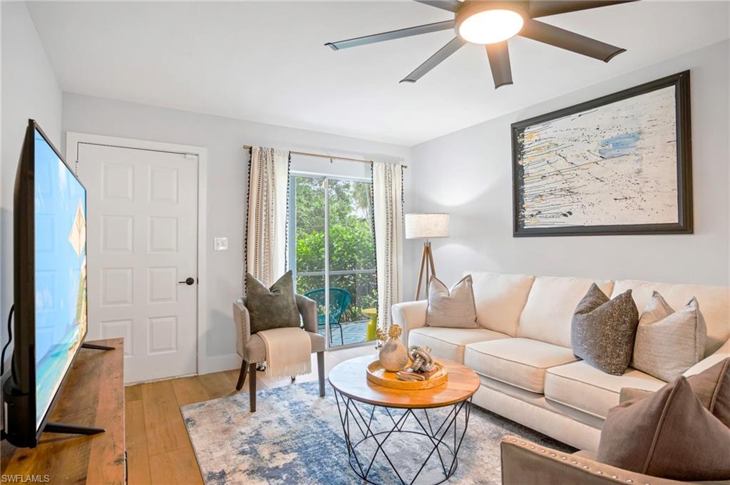 1275 7th Avenue North, Unit 201 Naples, FL 34102 - Photo 3 of 39 Living area featuring ceiling fan and hardwood / wood-style flooring