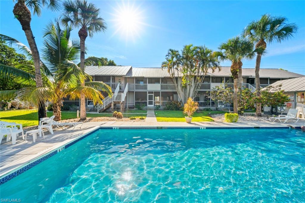 1275 7th Avenue North, Unit 201 Naples, FL 34102 - Photo 39 of 39 Community pool featuring stairs and a patio