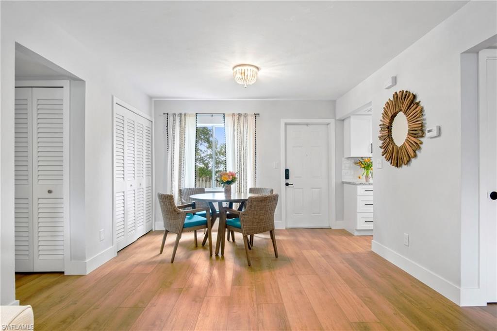 1275 7th Avenue North, Unit 201 Naples, FL 34102 - Photo 6 of 39 Dining area featuring baseboards and light wood-style floors