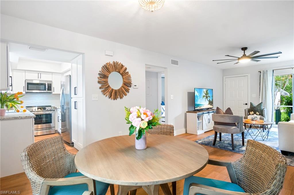 1275 7th Avenue North, Unit 201 Naples, FL 34102 - Photo 8 of 39 Dining space with light wood-type flooring and a ceiling fan