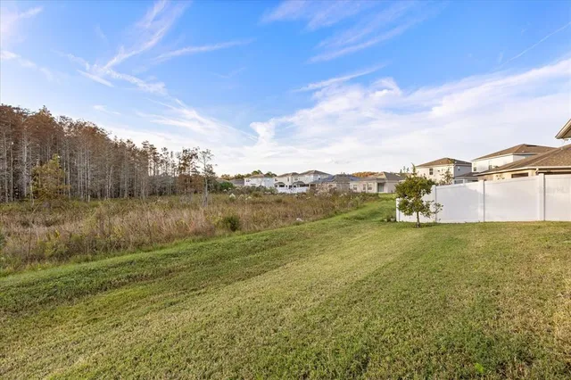 a living room with furniture and floor to ceiling windows