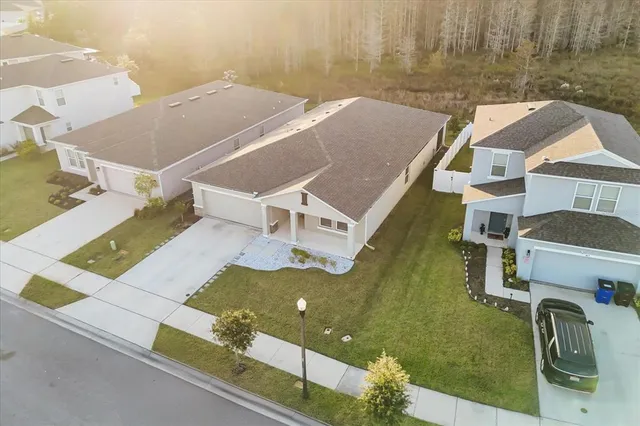 an aerial view of a house with a yard