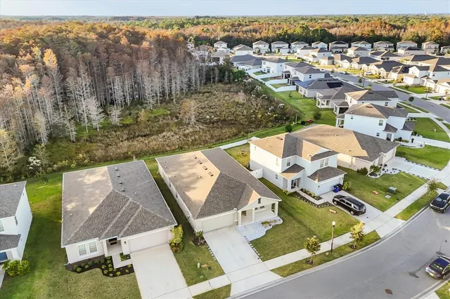 an aerial view of residential houses with yard and ocean view