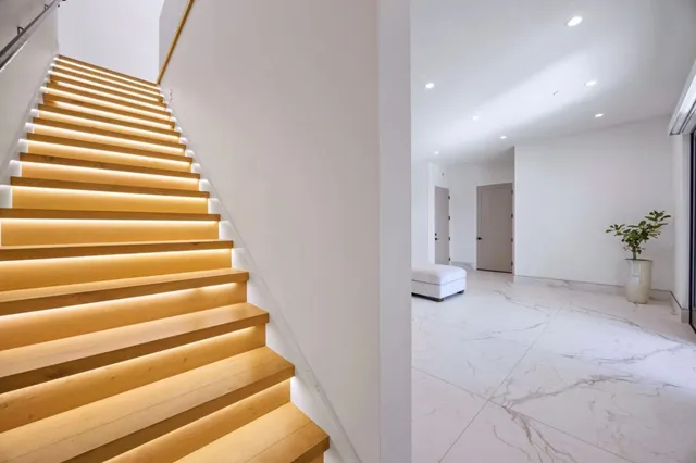 a view of entryway and hall with wooden floor
