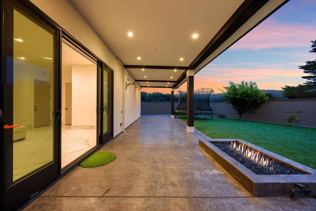a view of a patio with table and chairs