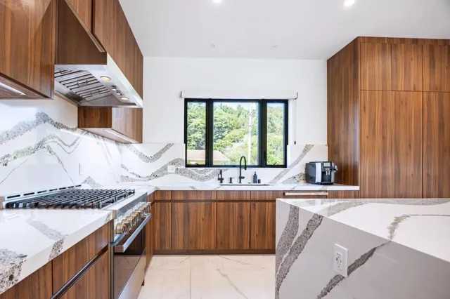 a kitchen with a sink stove and cabinets