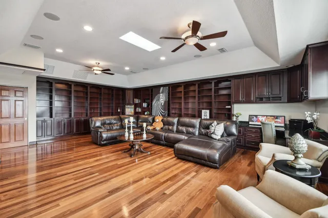 a living room with fireplace furniture and a large window