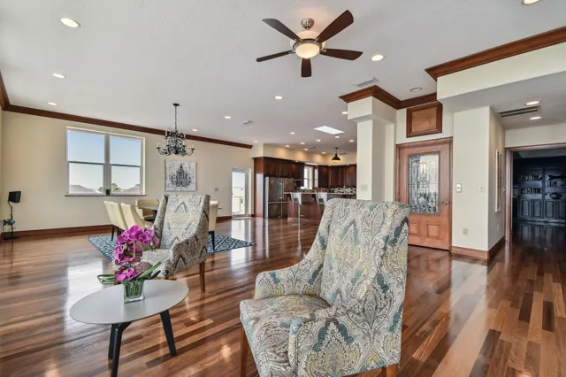 a kitchen with kitchen island granite countertop a refrigerator and wooden cabinets