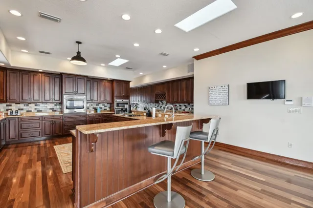 a kitchen with granite countertop a sink and a counter top space
