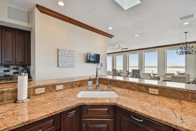 a bedroom with a bed and a flat tv screen on dresser