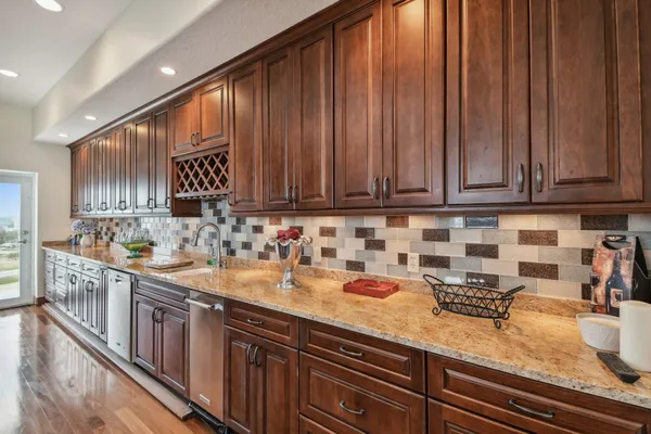a spacious bathroom with a granite countertop toilet sink and mirror