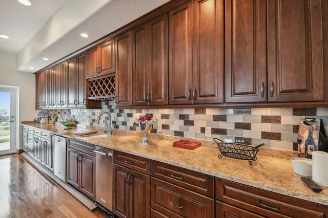 a spacious bathroom with a granite countertop toilet sink and mirror