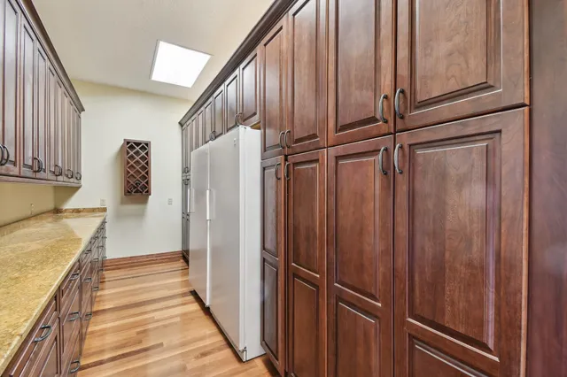 a en suite bathroom with a granite countertop sink and a mirror