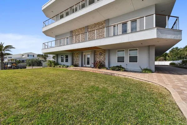 a living room with furniture a flat screen tv and a table