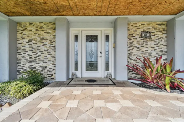 a living room with furniture and large windows