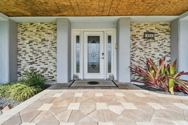 a living room with furniture and large windows