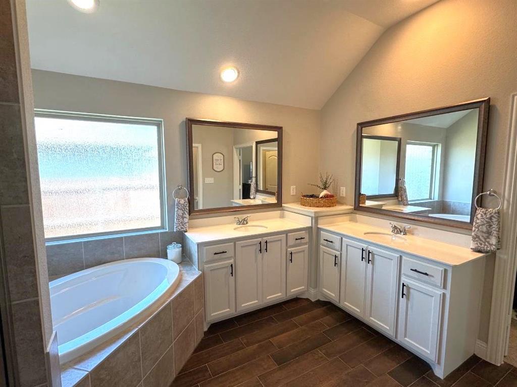 1455 Radecke Road Krum, TX 76249 - Photo 10 of 18 a spacious bathroom with a granite countertop tub sink and mirror