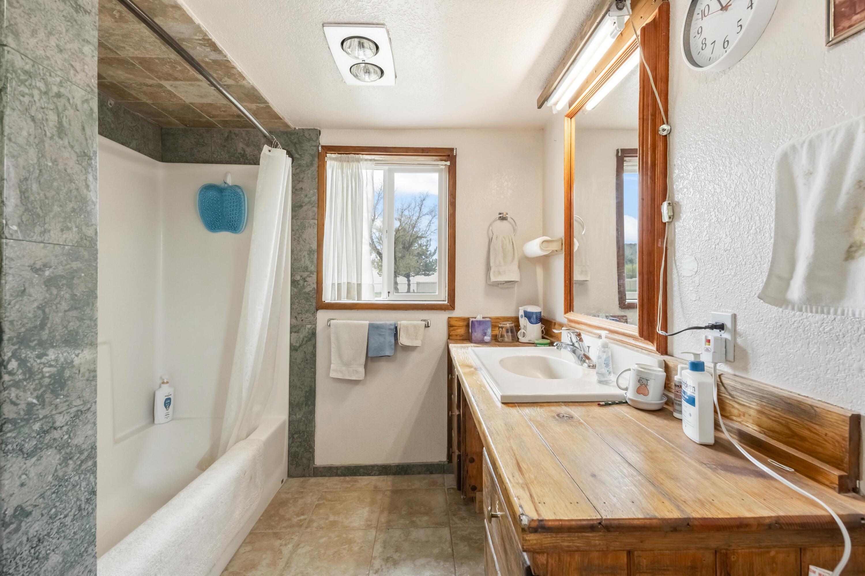 2010 Northeast Laughlin Road Prineville, OR 97754 - Photo 15 of 39 a bathroom with a tub sink and mirror