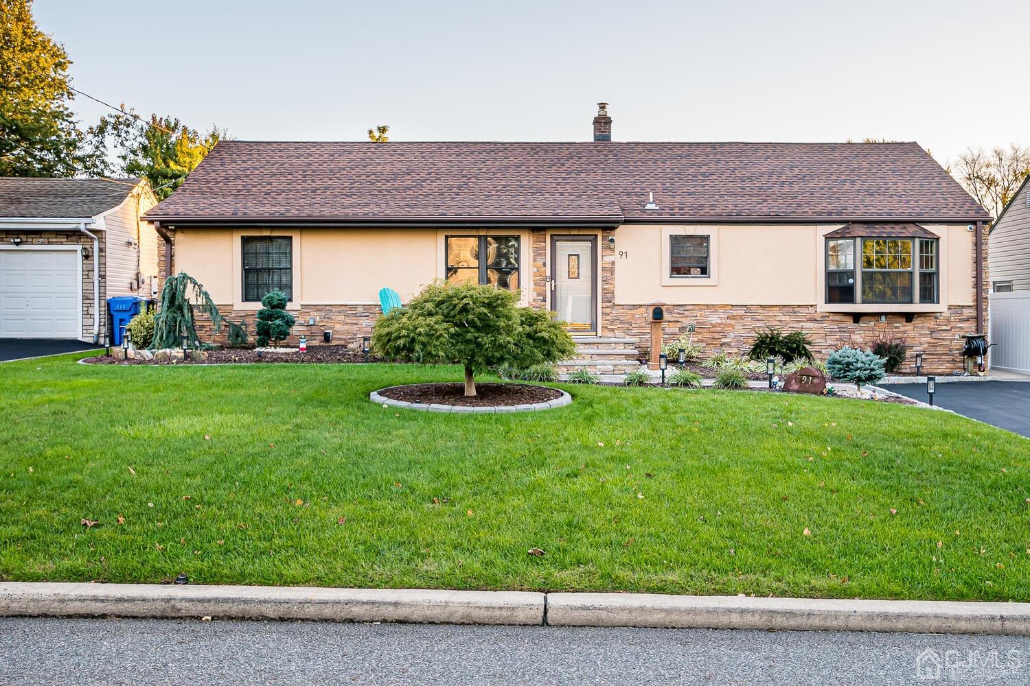 91 South Hill Road Colonia, NJ 07067 - Photo 1 of 46 a front view of a house with a garden and plants