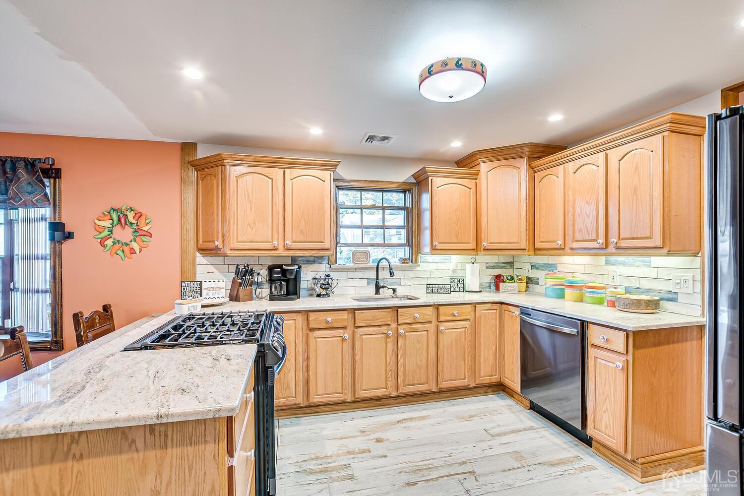 91 South Hill Road Colonia, NJ 07067 - Photo 11 of 46 a kitchen with a sink stove and cabinets