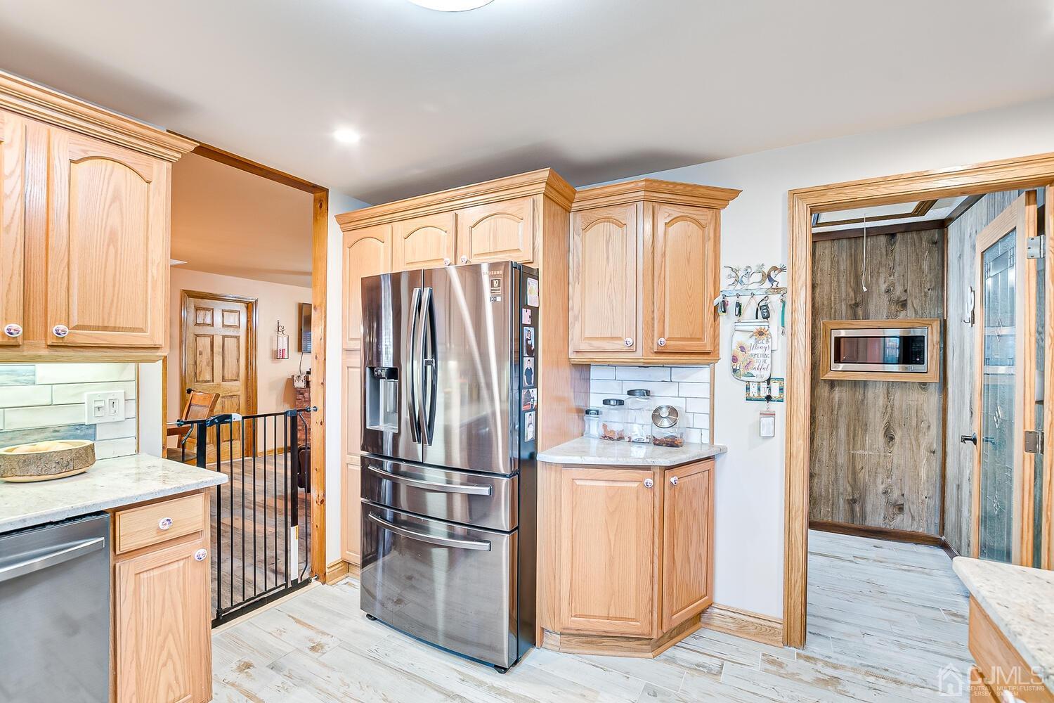 91 South Hill Road Colonia, NJ 07067 - Photo 12 of 46 a kitchen with stainless steel appliances granite countertop a refrigerator and a stove top oven