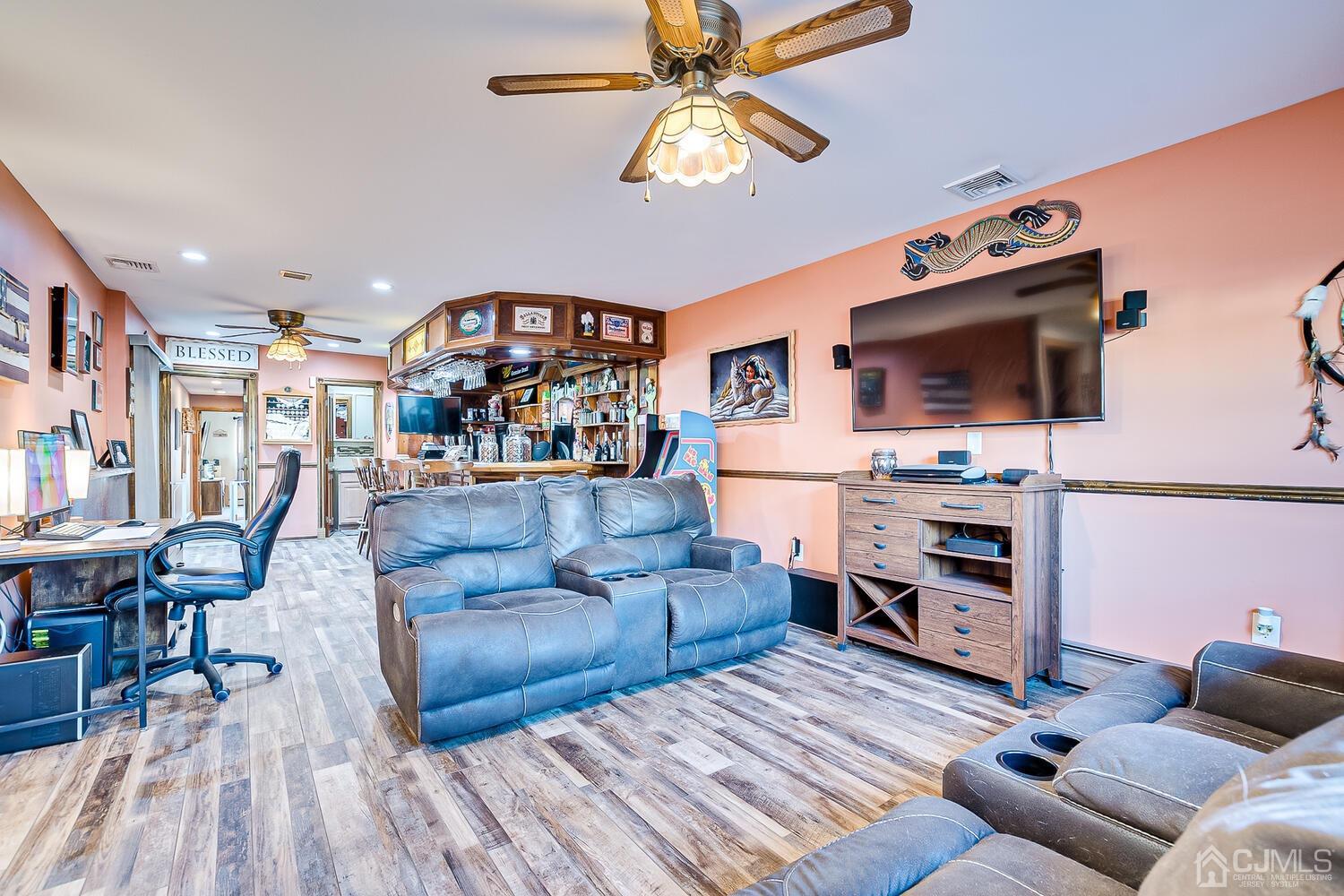 91 South Hill Road Colonia, NJ 07067 - Photo 15 of 46 a living room with furniture and a flat screen tv