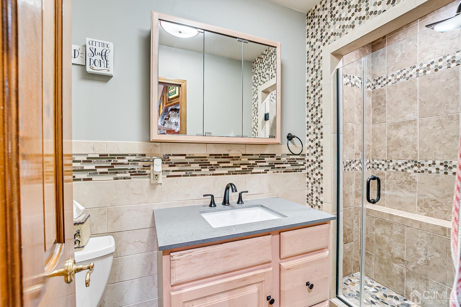 91 South Hill Road Colonia, NJ 07067 - Photo 20 of 46 a bathroom with a sink and a mirror