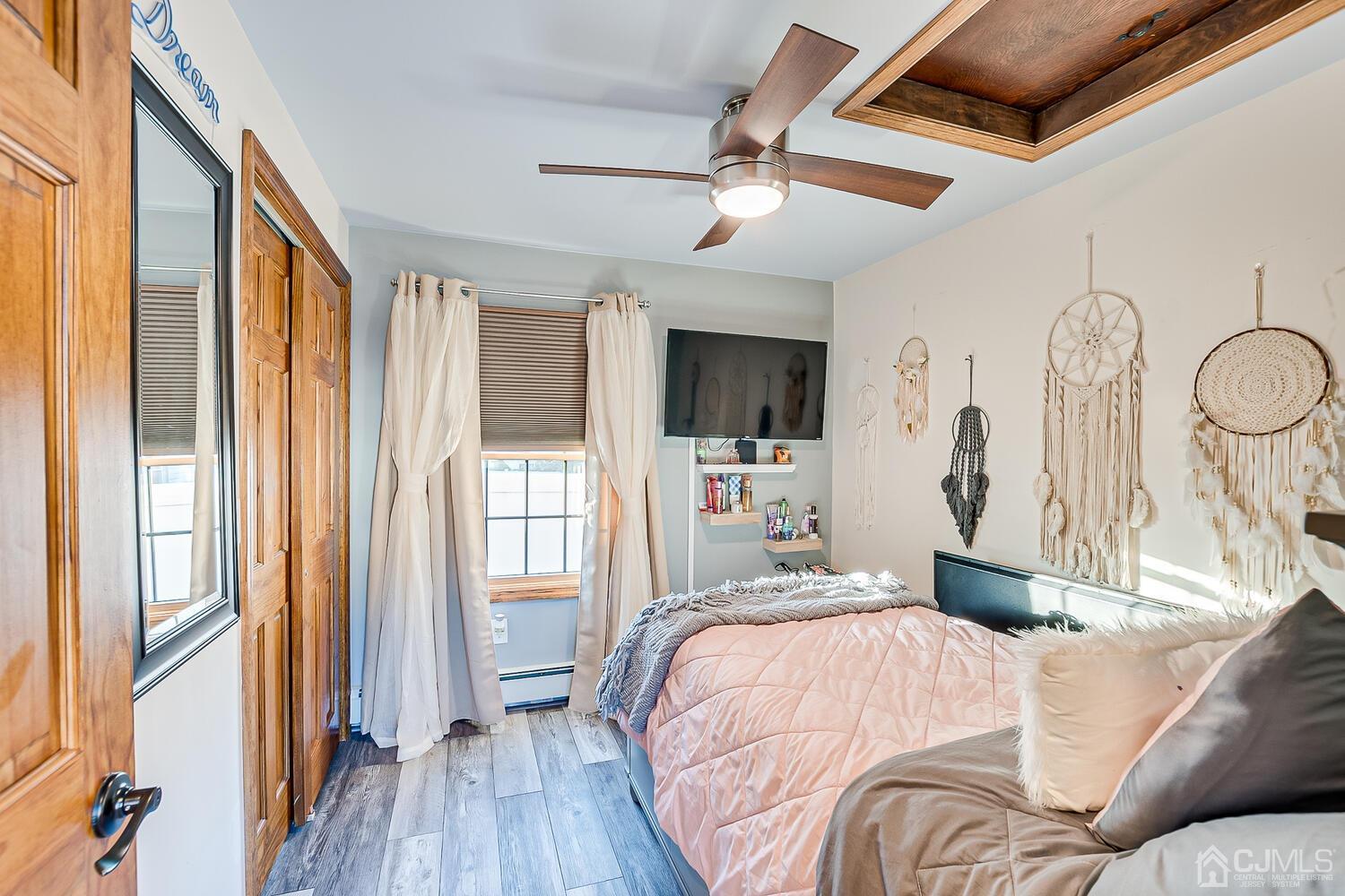 91 South Hill Road Colonia, NJ 07067 - Photo 21 of 46 a bedroom with a bed window and wooden floor