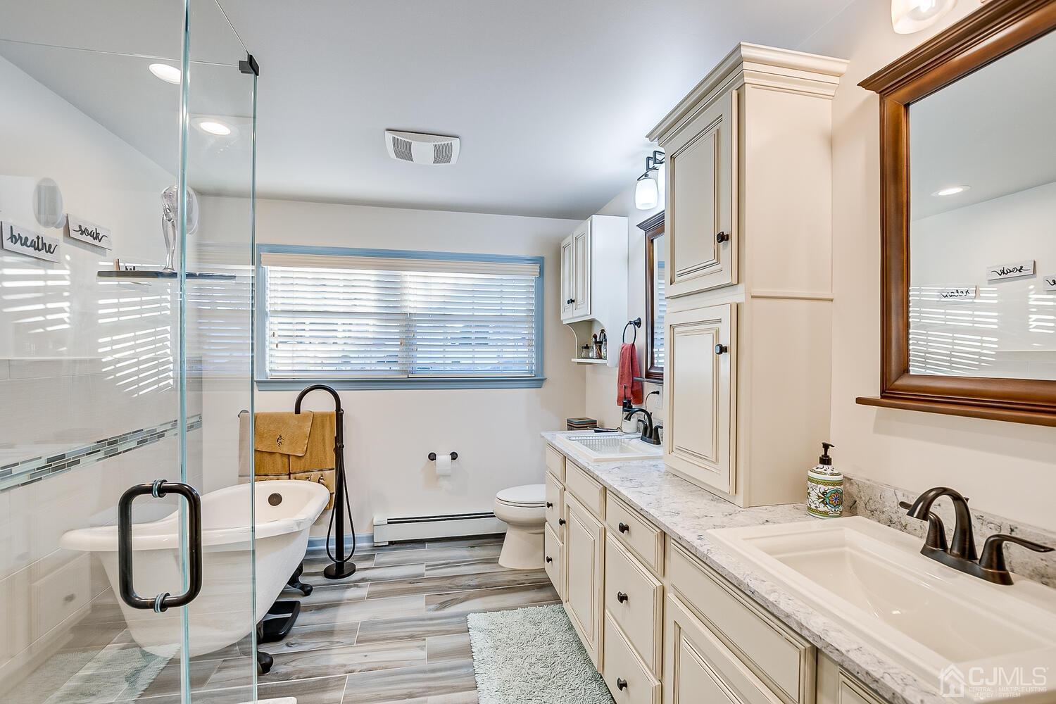91 South Hill Road Colonia, NJ 07067 - Photo 28 of 46 a bathroom with a double vanity sink window and a mirror