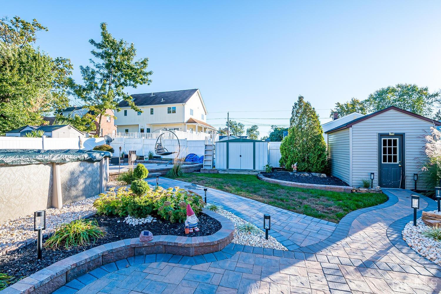 91 South Hill Road Colonia, NJ 07067 - Photo 33 of 46 a view of a backyard with plants and a patio