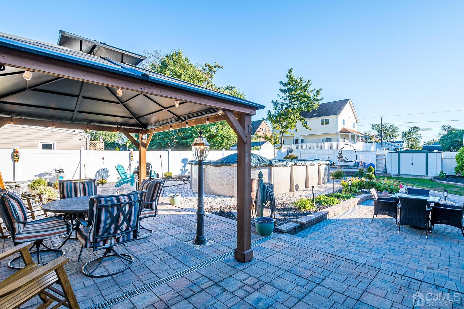 91 South Hill Road Colonia, NJ 07067 - Photo 40 of 46 a view of a patio with table and chairs potted plants with wooden floor