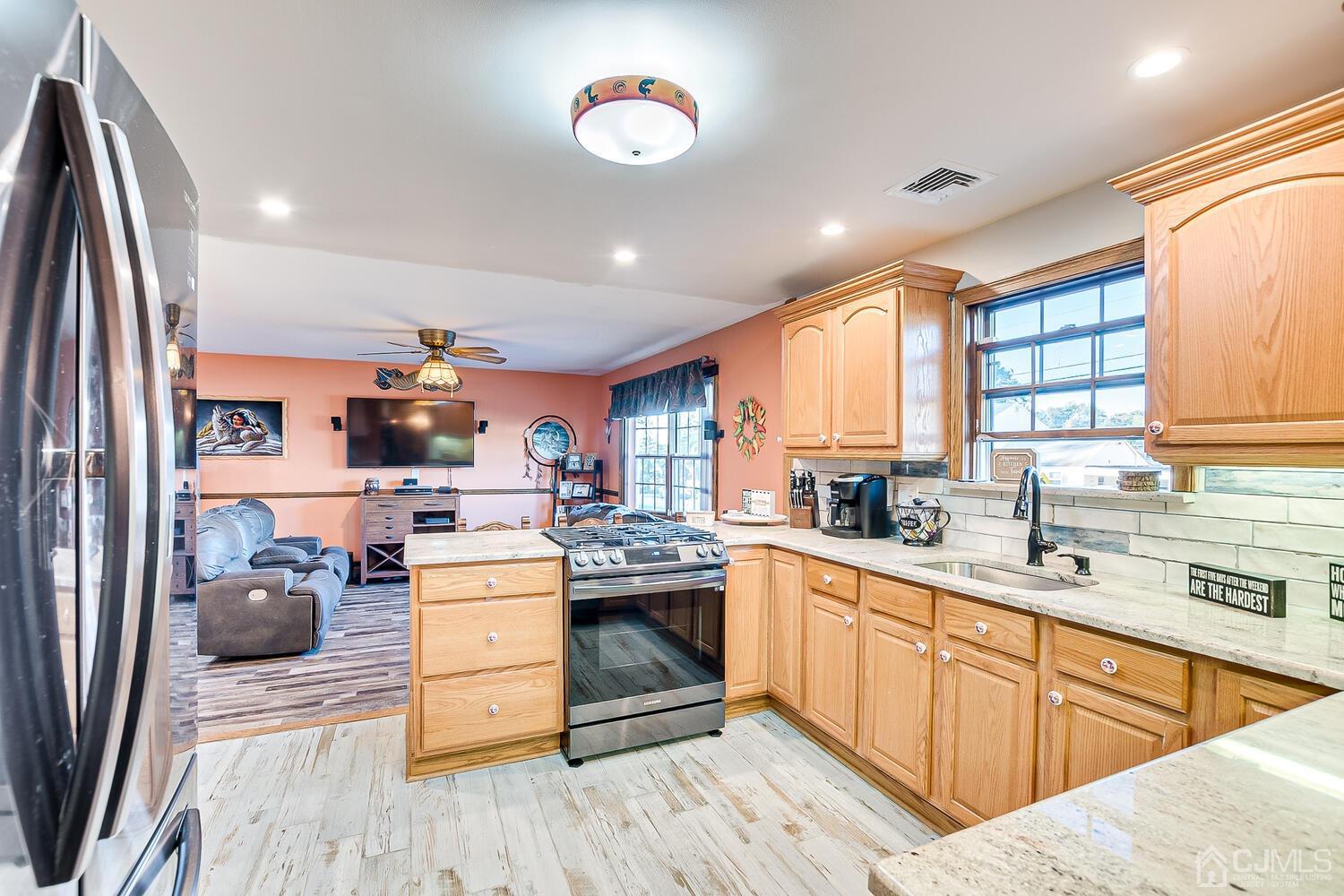 91 South Hill Road Colonia, NJ 07067 - Photo 9 of 46 a kitchen with a stove a sink and a refrigerator