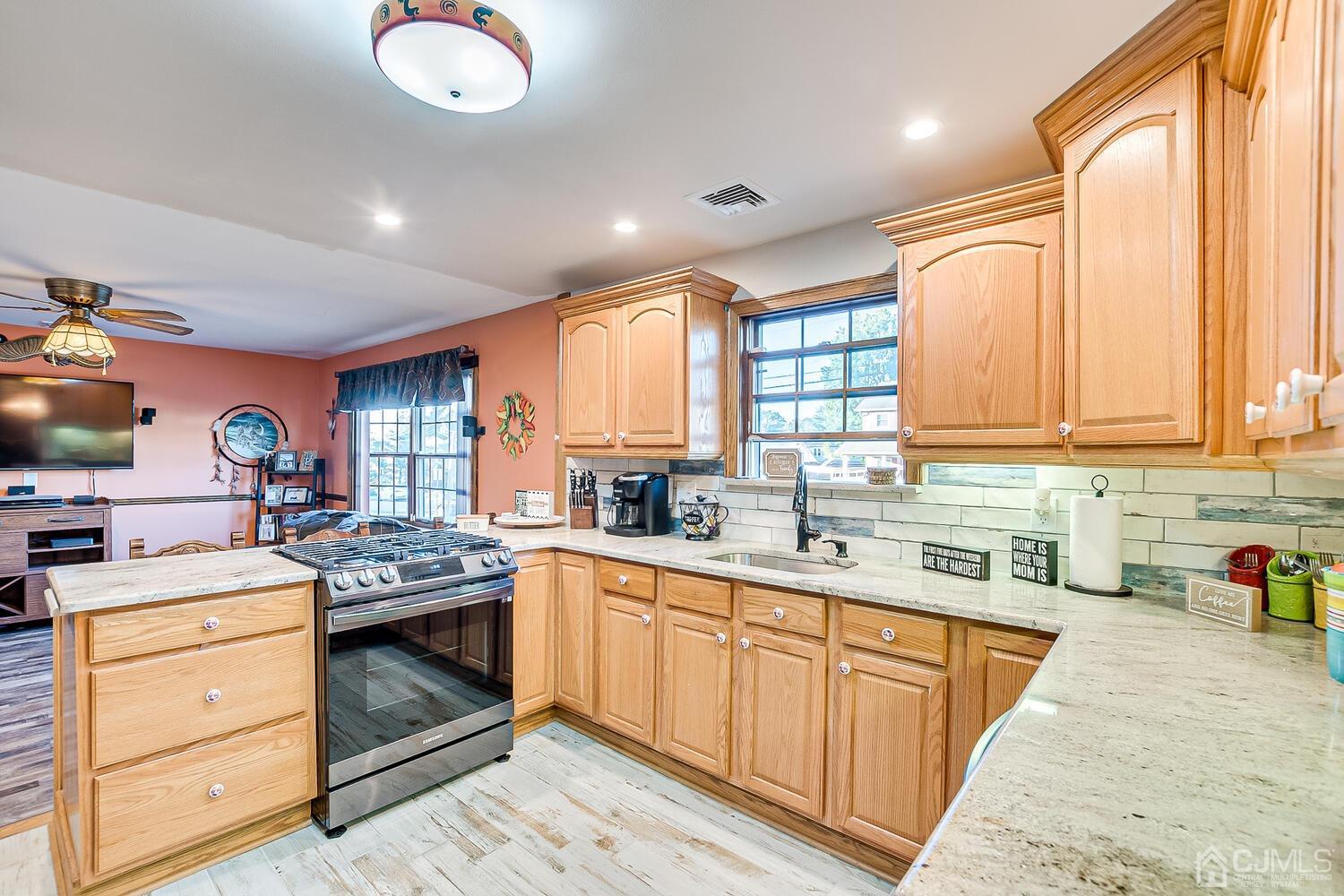 91 South Hill Road Colonia, NJ 07067 - Photo 10 of 46 a kitchen with a stove sink and cabinets