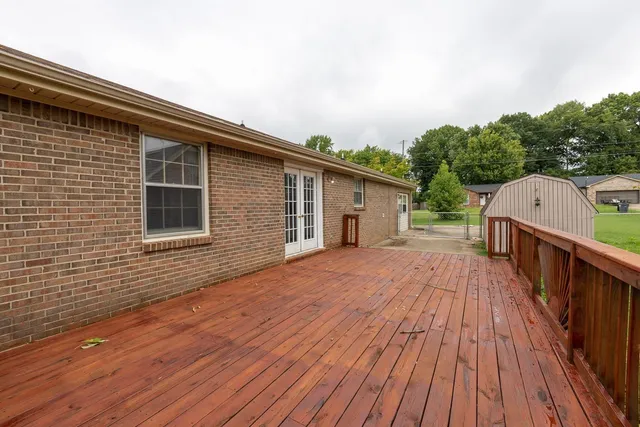 a backyard of a house with wooden floor