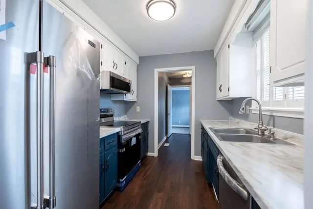 a kitchen with stainless steel appliances granite countertop a sink stove and refrigerator