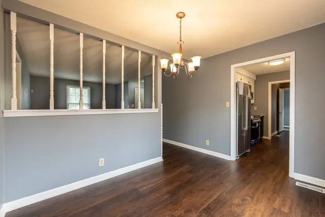 a view of a livingroom with a furniture wooden floor and chandelier