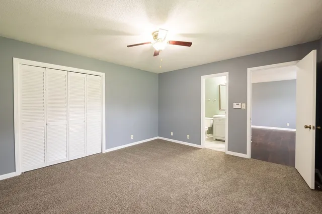 an empty room with cabinet and a ceiling fan