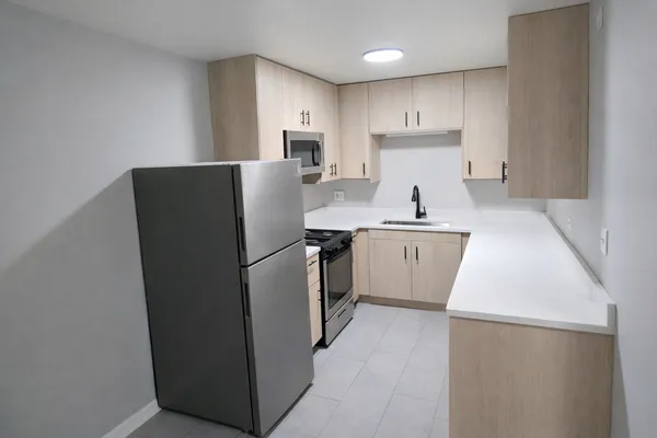 a kitchen with a sink a refrigerator and a stove