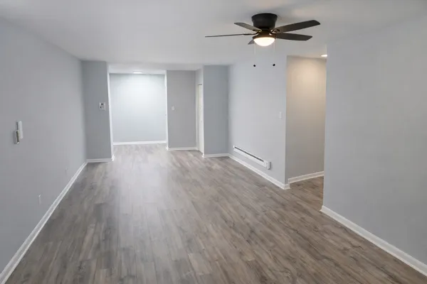 wooden floor in an empty room with a window