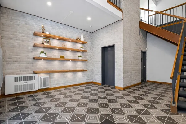 a view of a hallway with wooden cabinets
