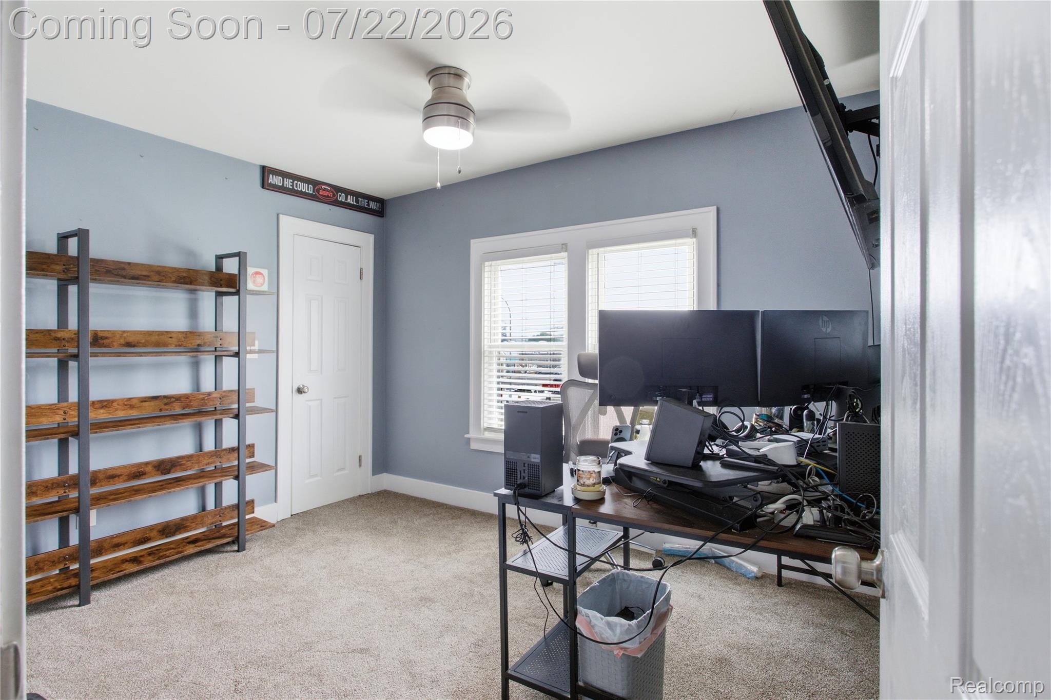 32127 Utica Road Fraser, MI 48026 - Photo 26 of 43 Carpeted room featuring a ceiling fan with integrated lighting, a white door, and two windows