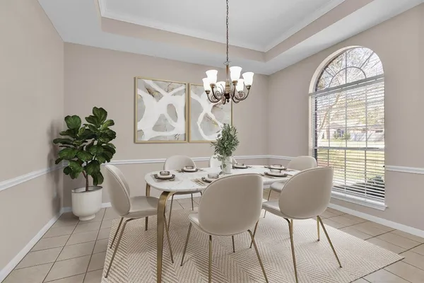 a view of a dining room with furniture and a chandelier