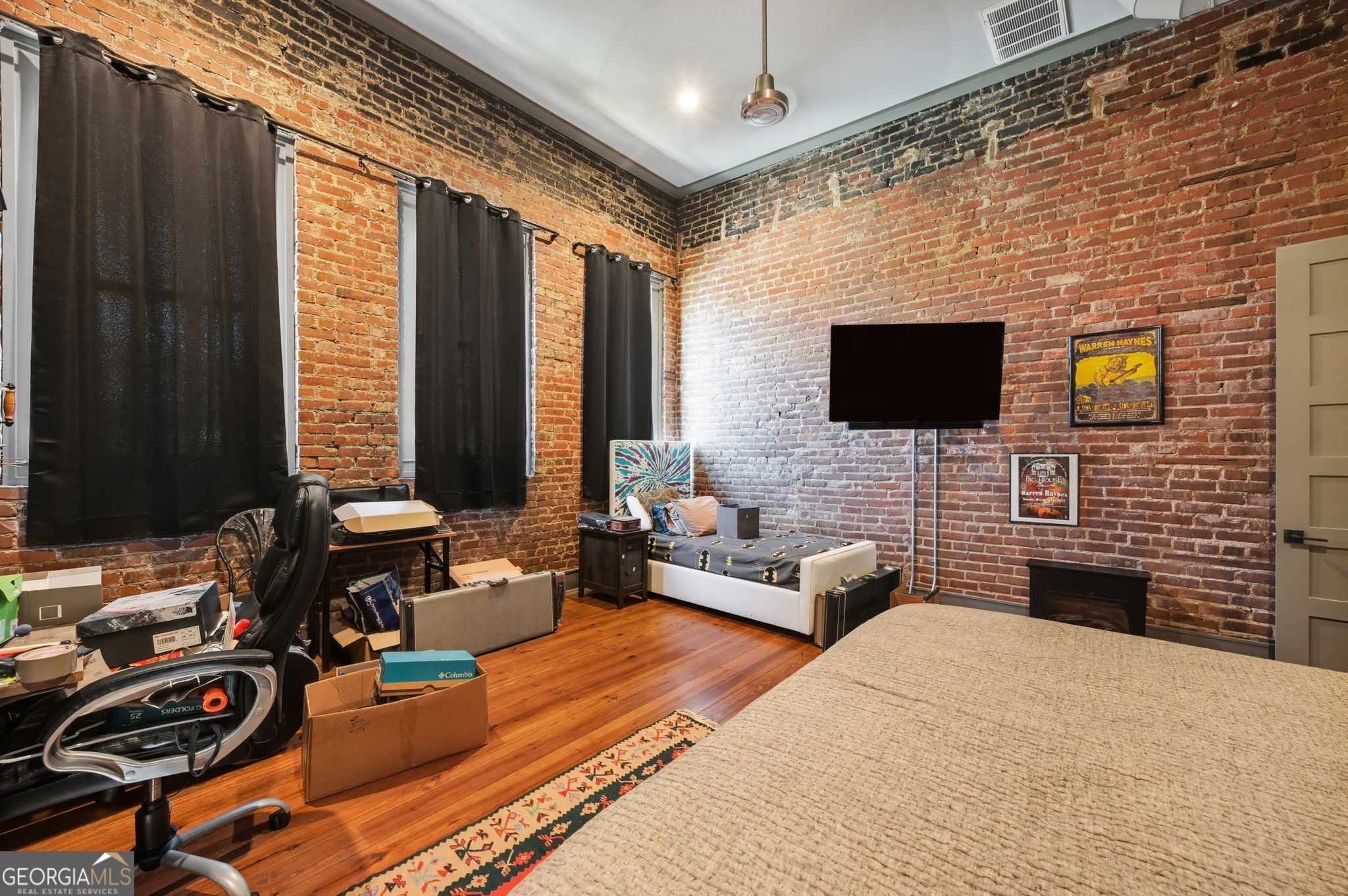 534 2nd Street Macon, GA 31201 - Photo 21 of 25 a bedroom with furniture a flat screen tv and a fireplace