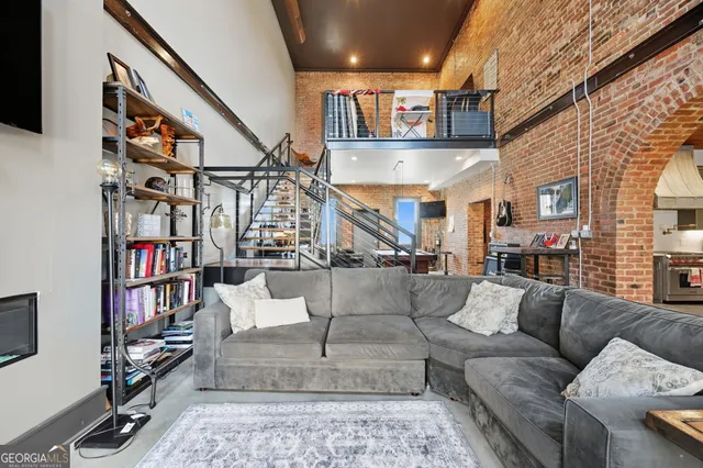 a view of a livingroom with furniture and a book shelf